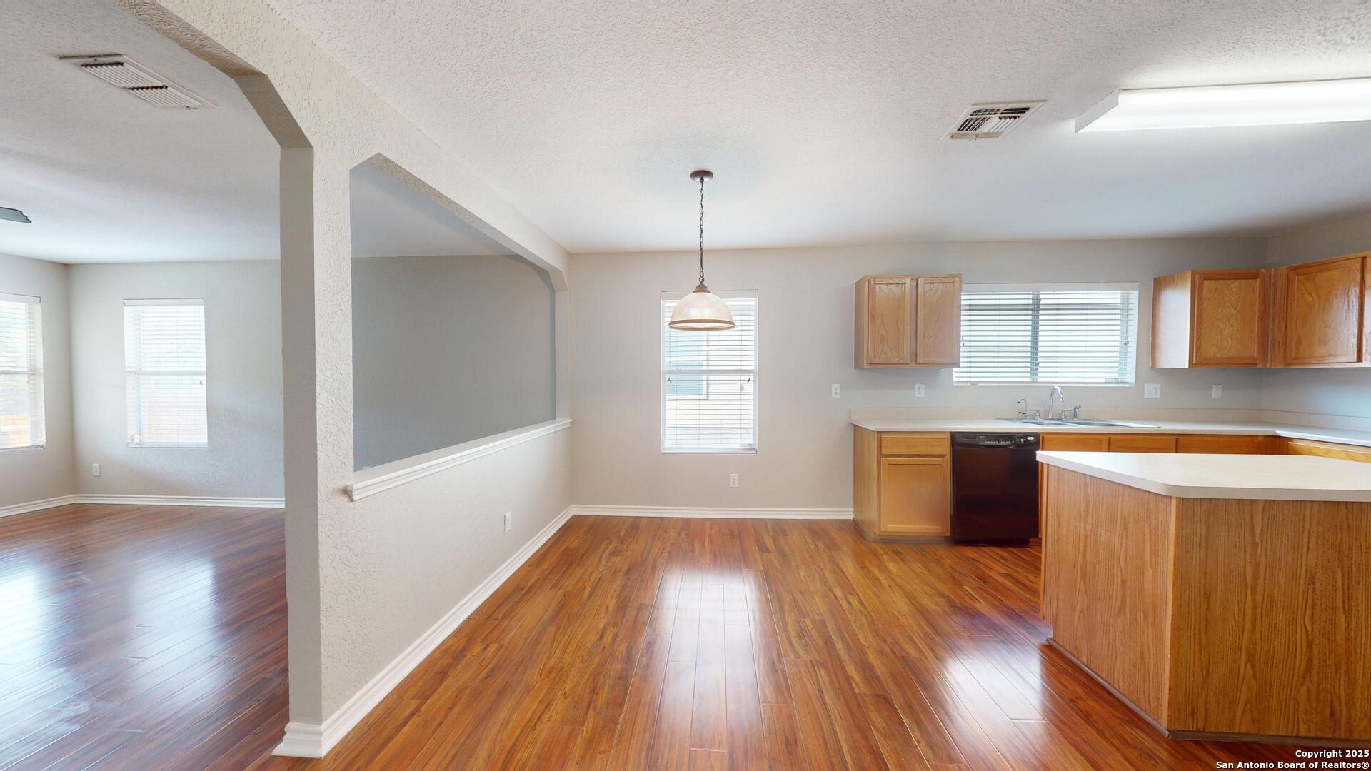 9515 Boatman Pier Converse, TX 78109 - Photo 13 of 41 a kitchen with wooden floors and window