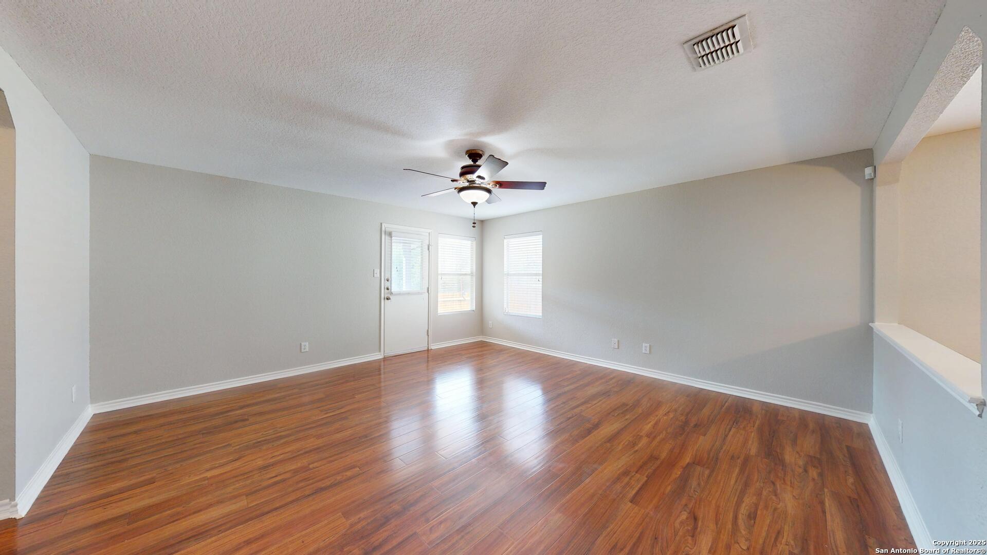 9515 Boatman Pier Converse, TX 78109 - Photo 14 of 41 a view of an empty room with wooden floor and a window