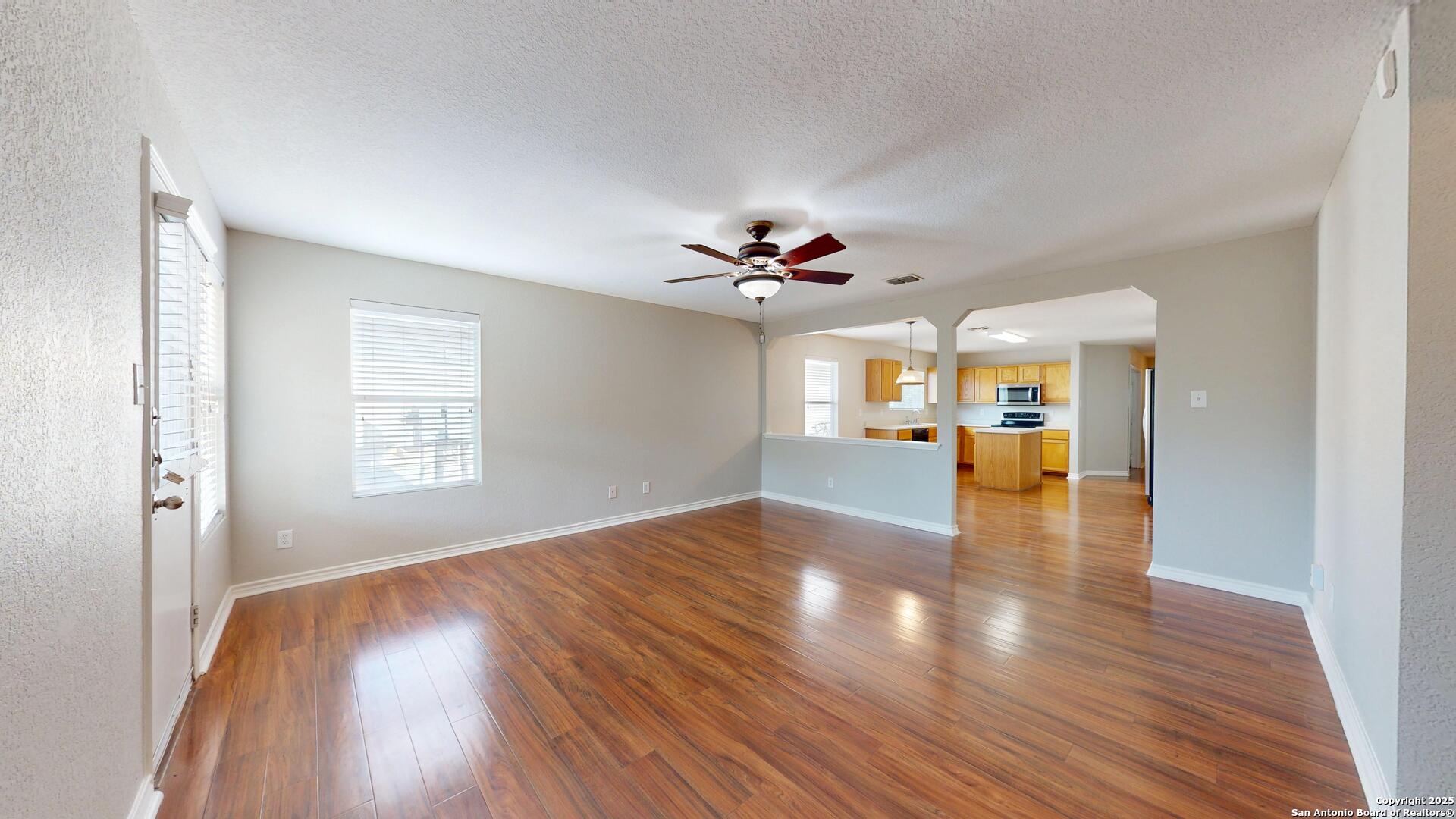 9515 Boatman Pier Converse, TX 78109 - Photo 15 of 41 a view of a livingroom with a ceiling fan and wooden floor