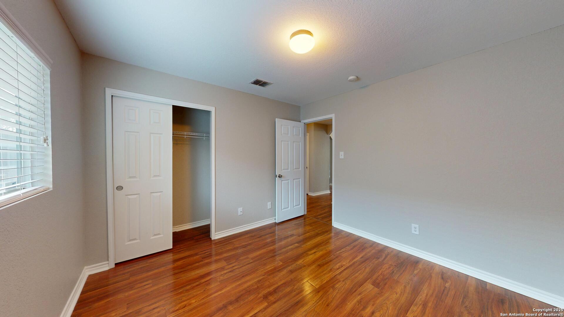 9515 Boatman Pier Converse, TX 78109 - Photo 20 of 41 an empty room with wooden floor and windows