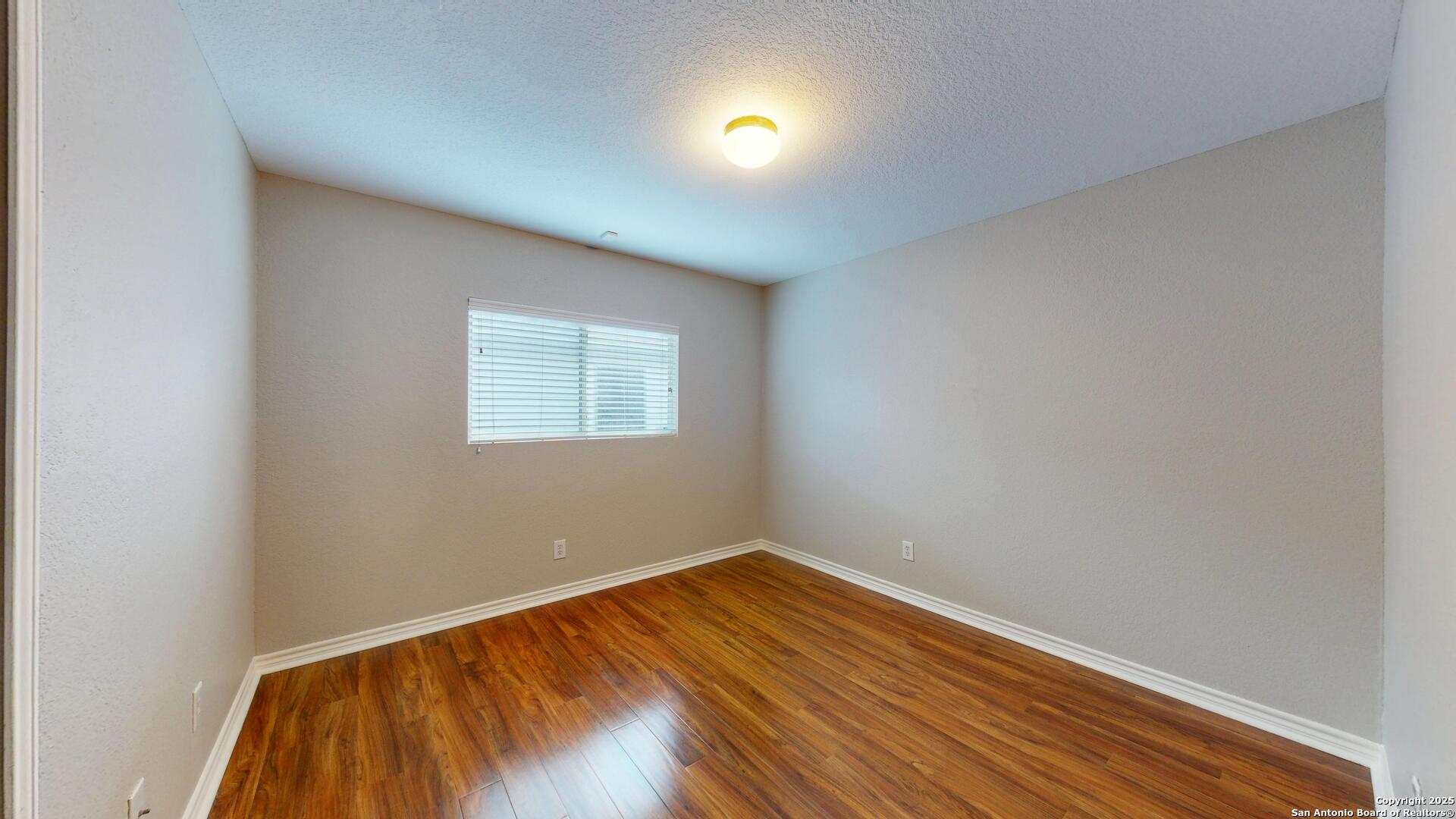 9515 Boatman Pier Converse, TX 78109 - Photo 23 of 41 a view of a room with wooden floor and windows