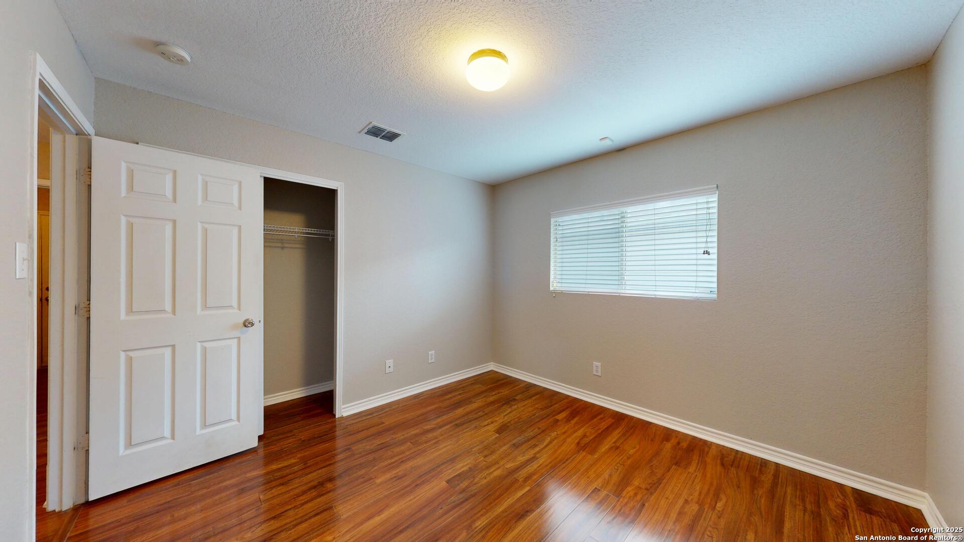 9515 Boatman Pier Converse, TX 78109 - Photo 26 of 41 an empty room with wooden floor and windows