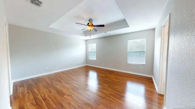 wooden floor in an empty room with a window