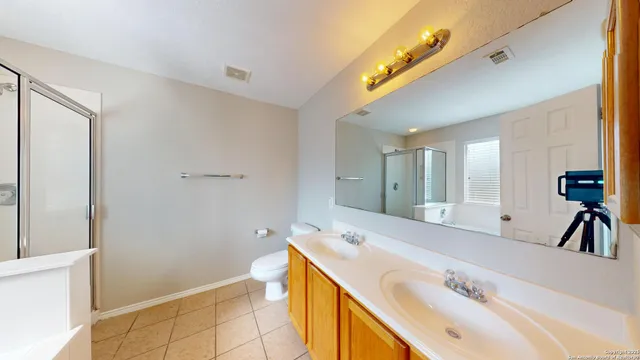a spacious bathroom with a tub sink and mirror
