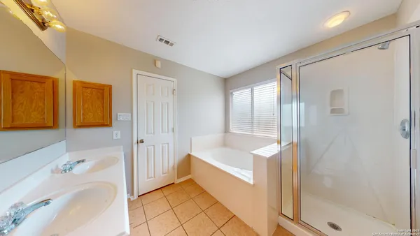a bathroom with a tub shower and sink