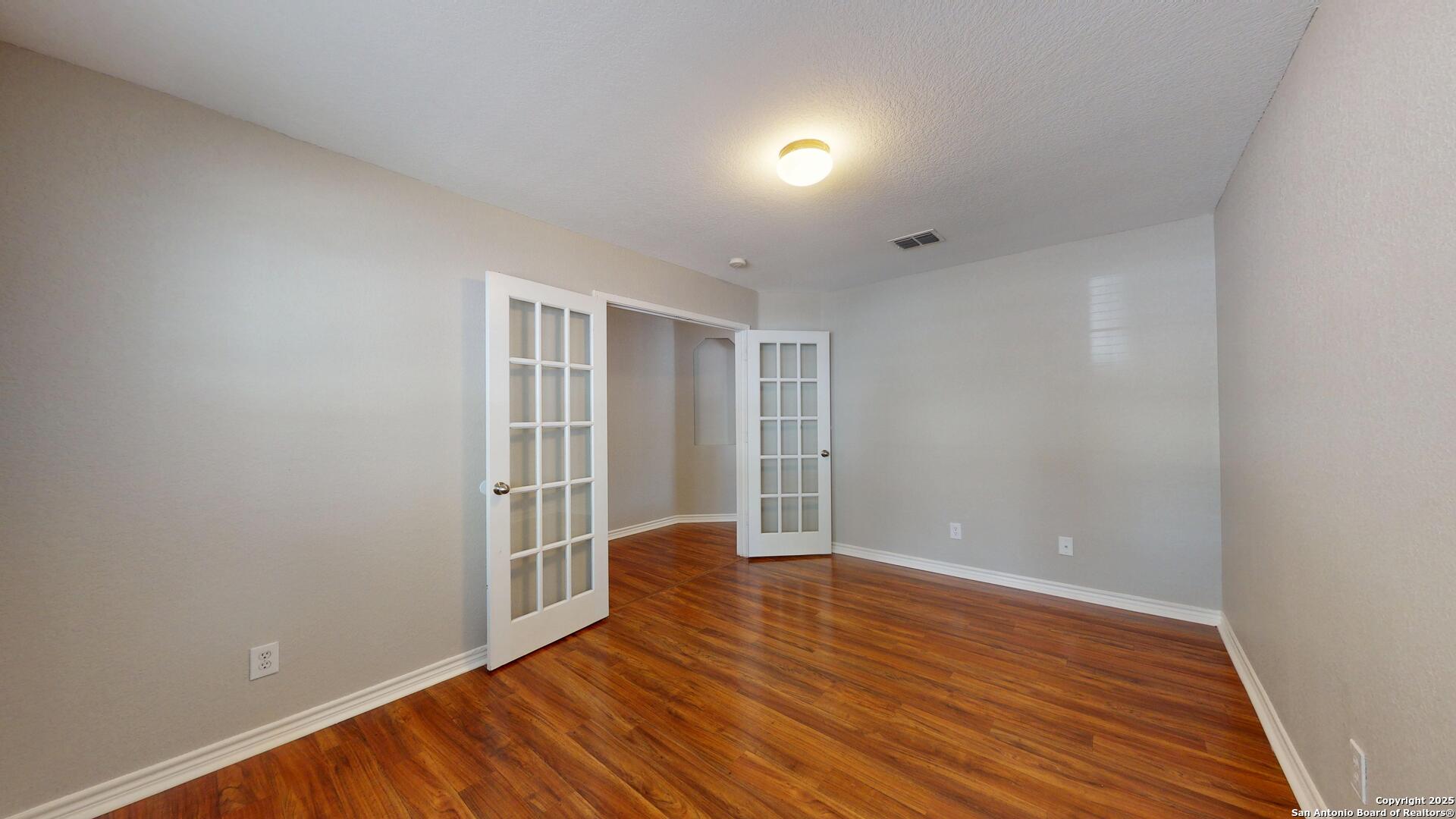 9515 Boatman Pier Converse, TX 78109 - Photo 5 of 41 wooden floor in an empty room with a window