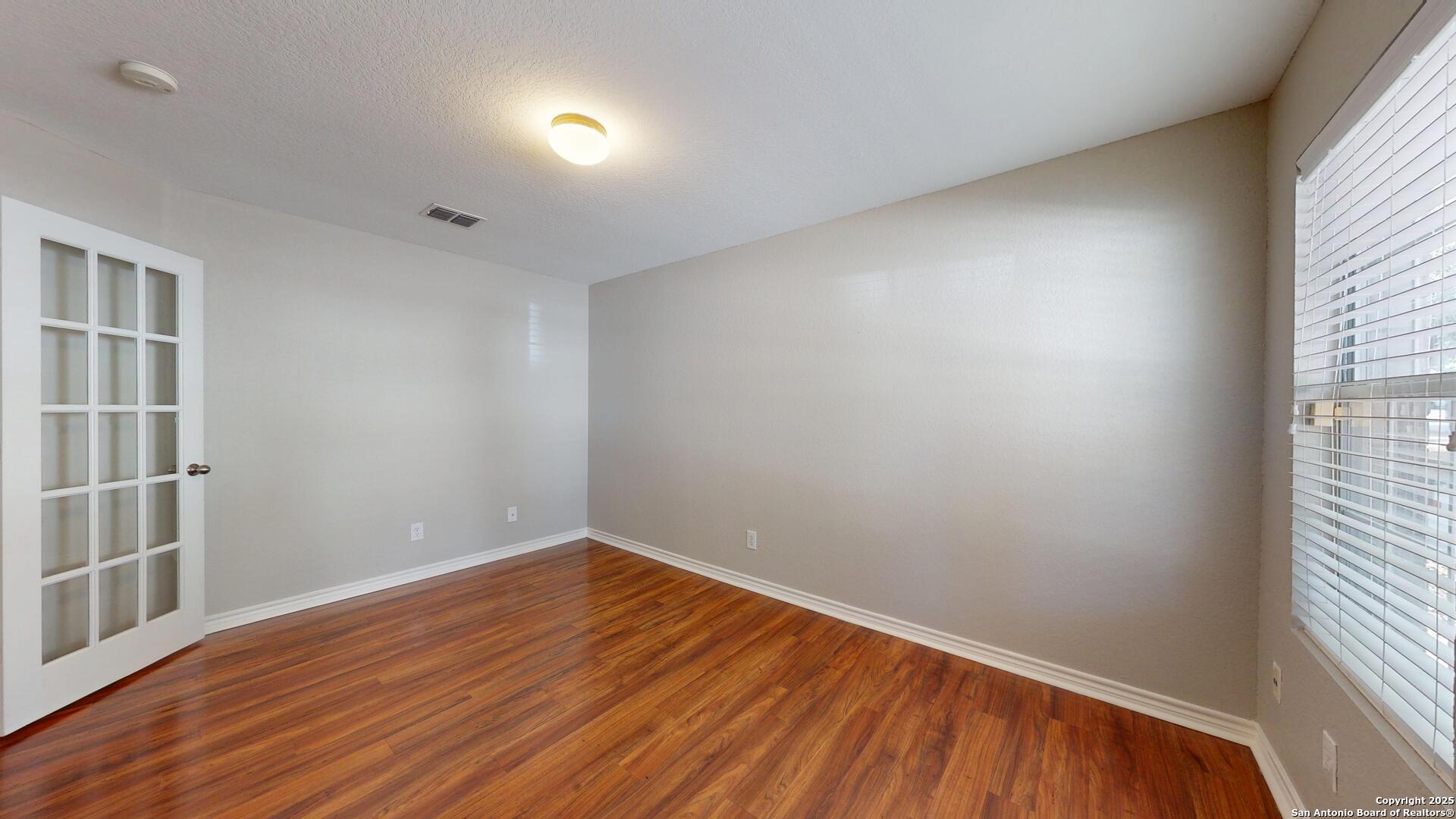 9515 Boatman Pier Converse, TX 78109 - Photo 6 of 41 an empty room with wooden floor and windows