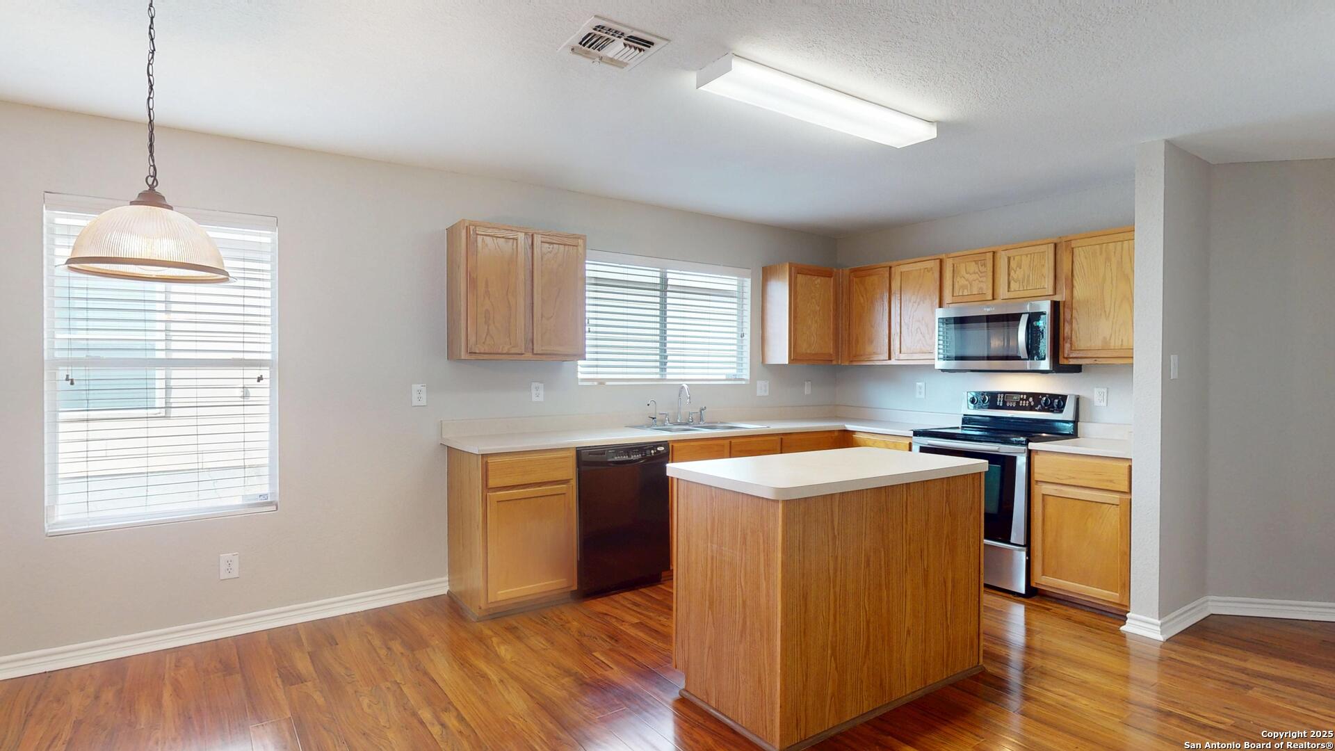 9515 Boatman Pier Converse, TX 78109 - Photo 9 of 41 a kitchen with stainless steel appliances granite countertop a sink stove and refrigerator