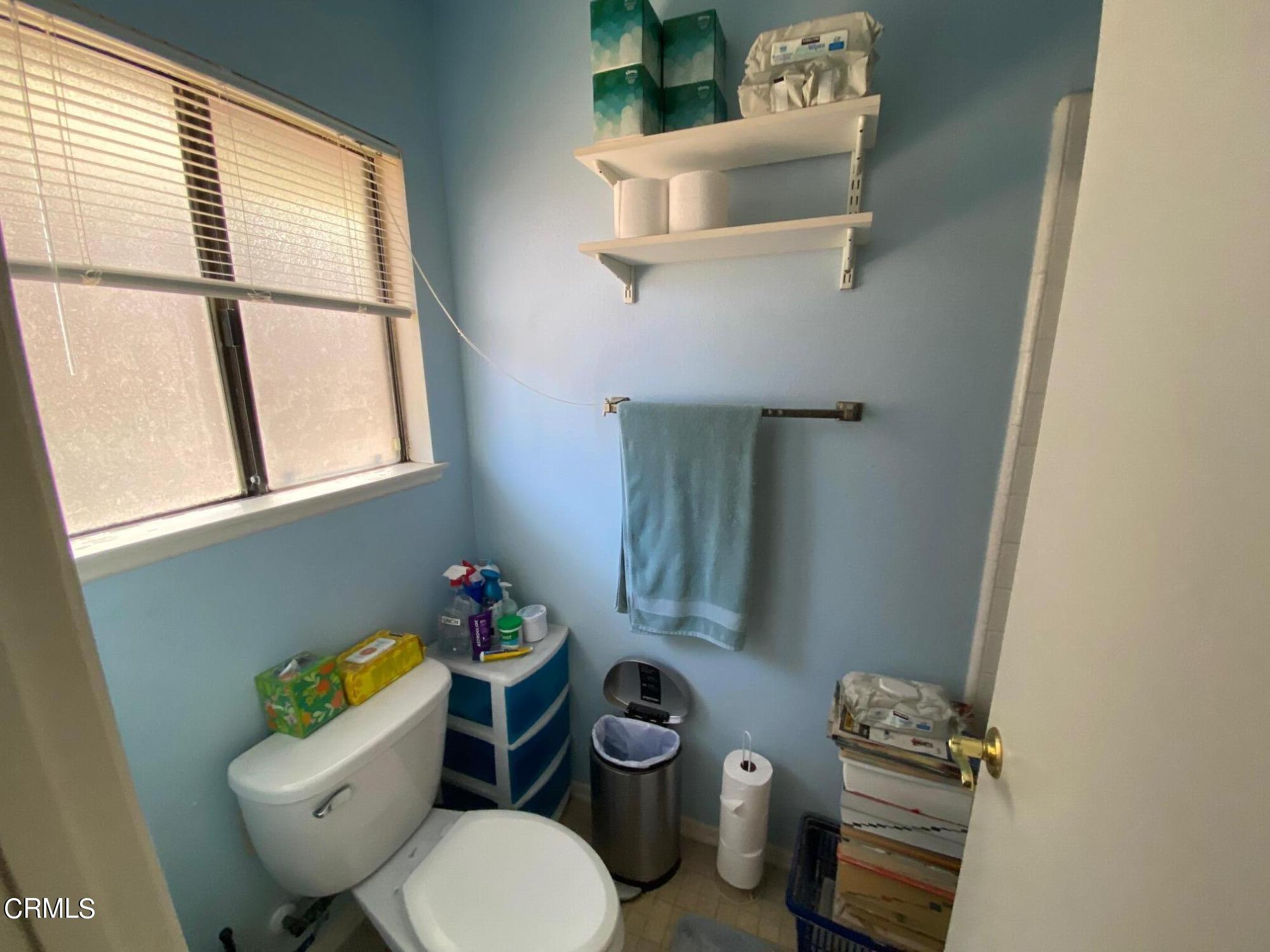 13657 Gunsmoke Road Moorpark, CA 93021 - Photo 13 of 26 a bathroom with a toilet a sink and a window