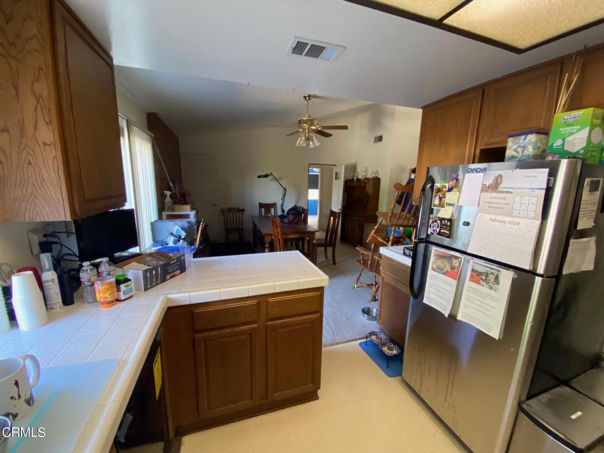 13657 Gunsmoke Road Moorpark, CA 93021 - Photo 5 of 26 a view of a kitchen with fridge and workspace