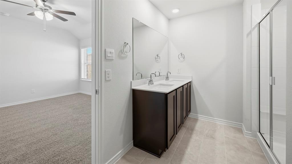 3513 Amaretto Road Aubrey, TX 76227 - Photo 2 of 34 a bathroom with a sink and a mirror