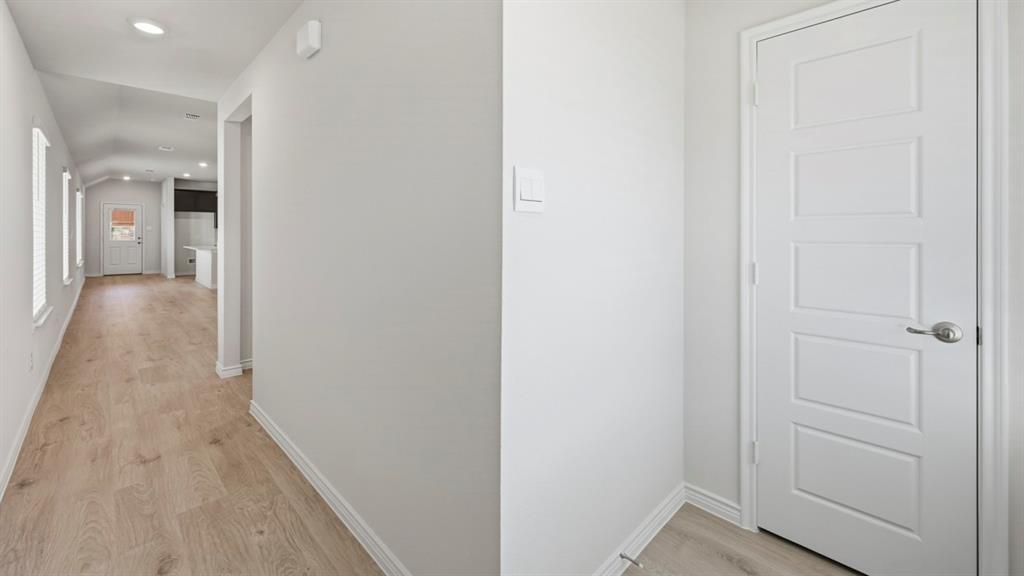 3513 Amaretto Road Aubrey, TX 76227 - Photo 7 of 34 a view of a hallway with wooden floor