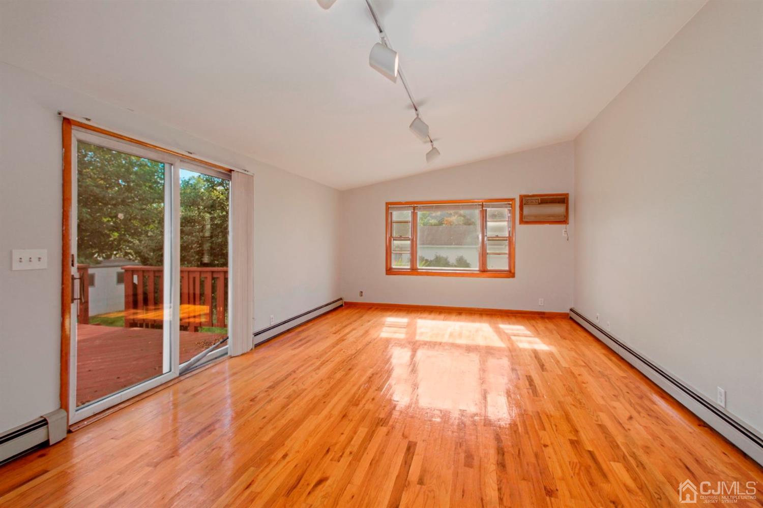 159 Vineyard Road Edison, NJ 08817 - Photo 14 of 30 a view of an empty room with wooden floor and a window