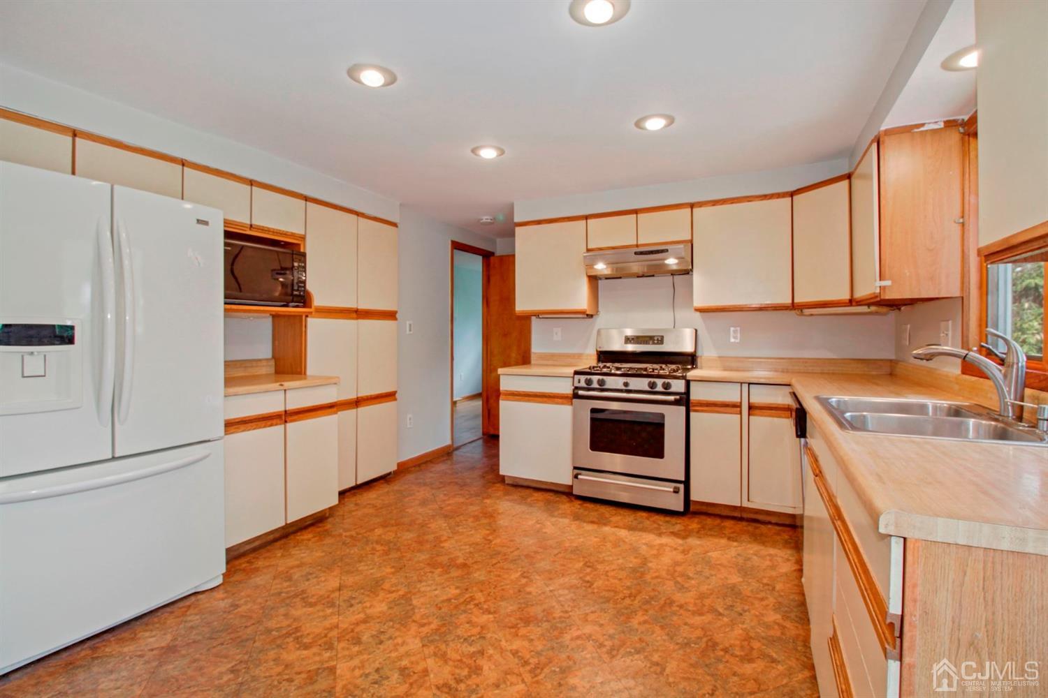 159 Vineyard Road Edison, NJ 08817 - Photo 17 of 30 a kitchen with stainless steel appliances a stove sink and cabinets