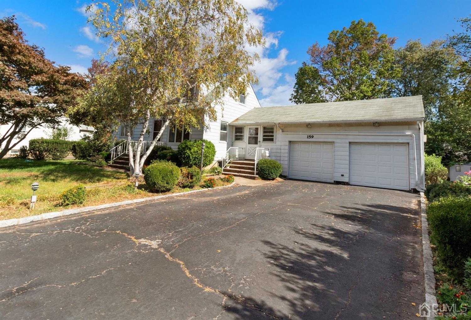 159 Vineyard Road Edison, NJ 08817 - Photo 3 of 30 a front view of a house with a yard and garage