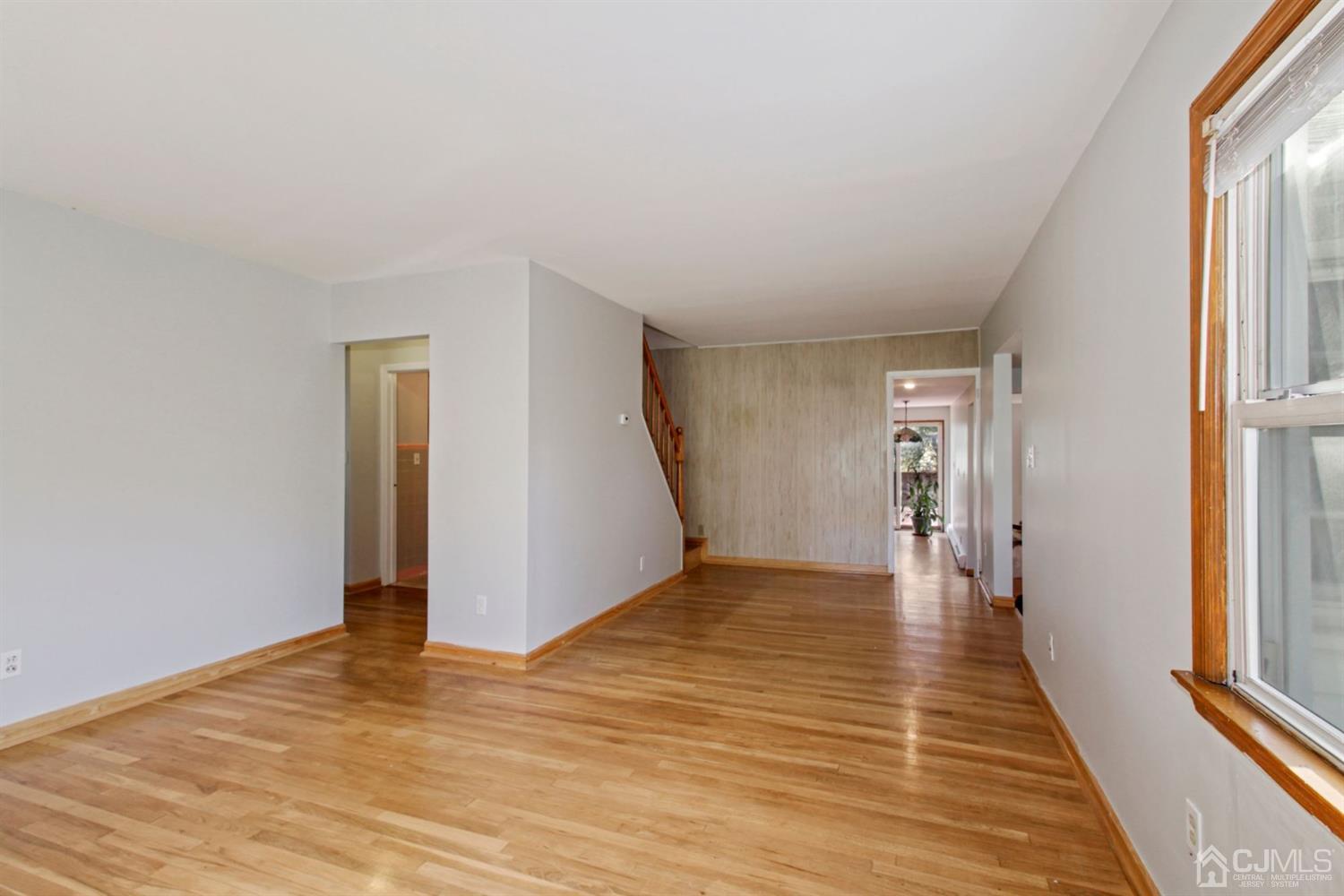 159 Vineyard Road Edison, NJ 08817 - Photo 5 of 30 a view of a livingroom with wooden floor and stairs