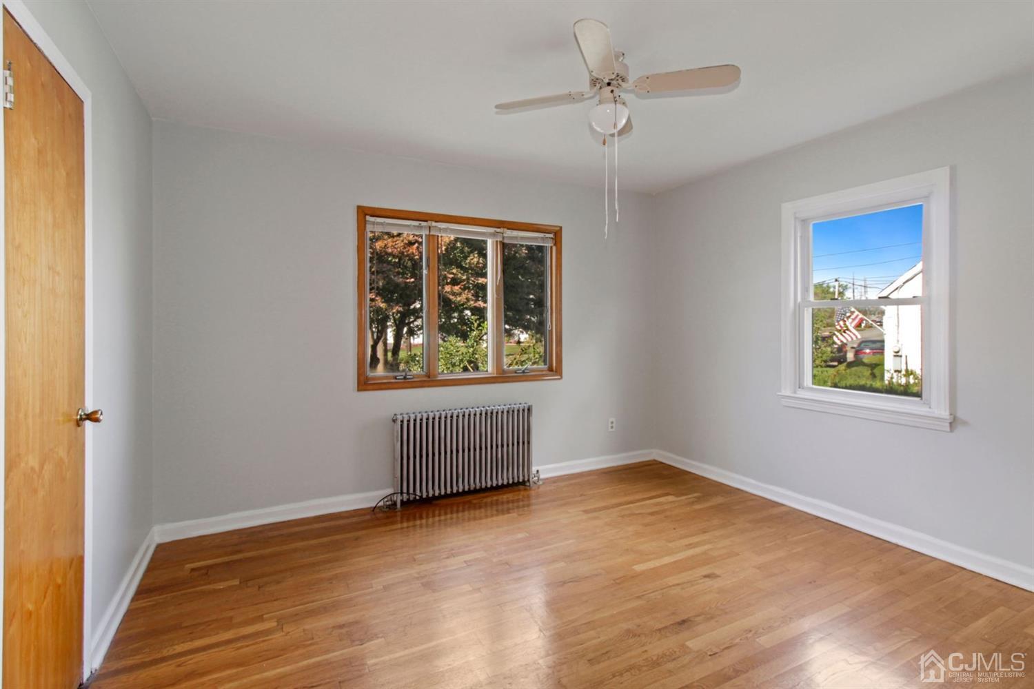 159 Vineyard Road Edison, NJ 08817 - Photo 6 of 30 a view of empty room with wooden floor and fan