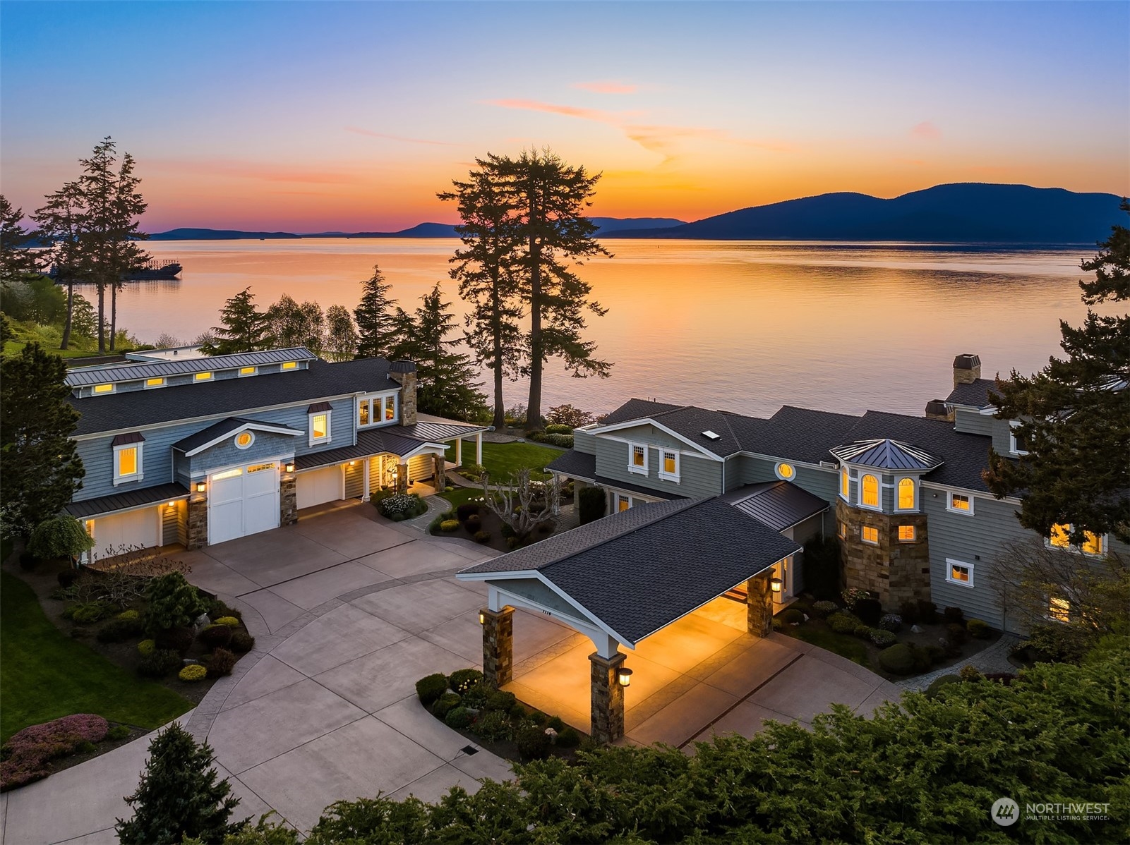 an aerial view of a house with swimming pool and lake view