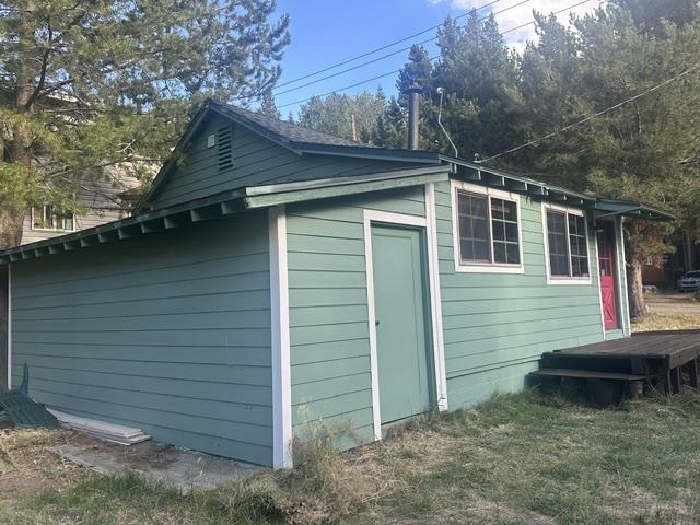 673 Minaret Road June Lake, CA 93529 - Photo 6 of 22 Horizontal siding exterior with white trim, multiple windows, and a dark wood deck