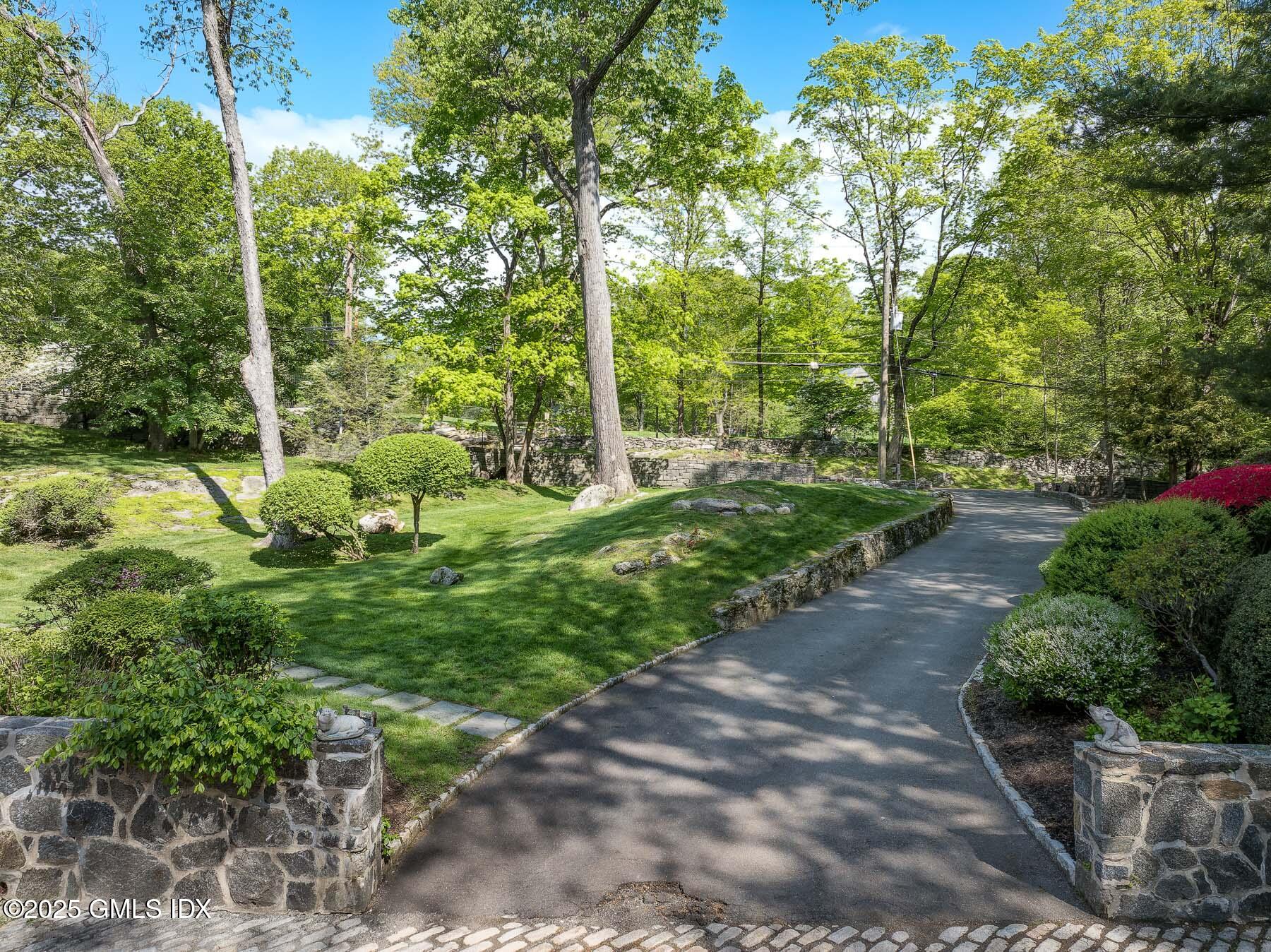 78 Khakum Wood Road Greenwich, CT 06831 - Photo 20 of 27 a view of a green yard with large trees