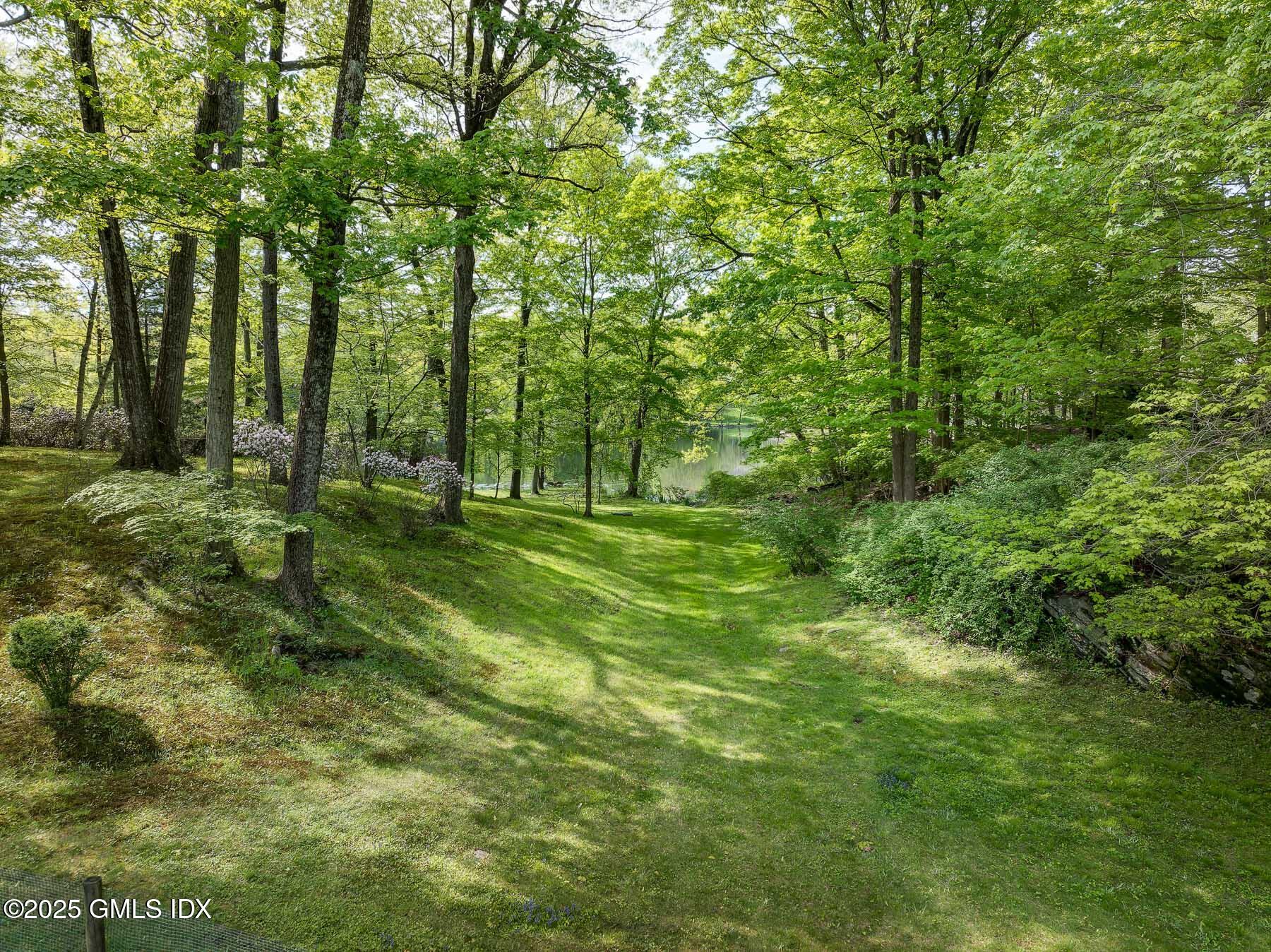 78 Khakum Wood Road Greenwich, CT 06831 - Photo 22 of 27 a backyard of a house with lots of green space