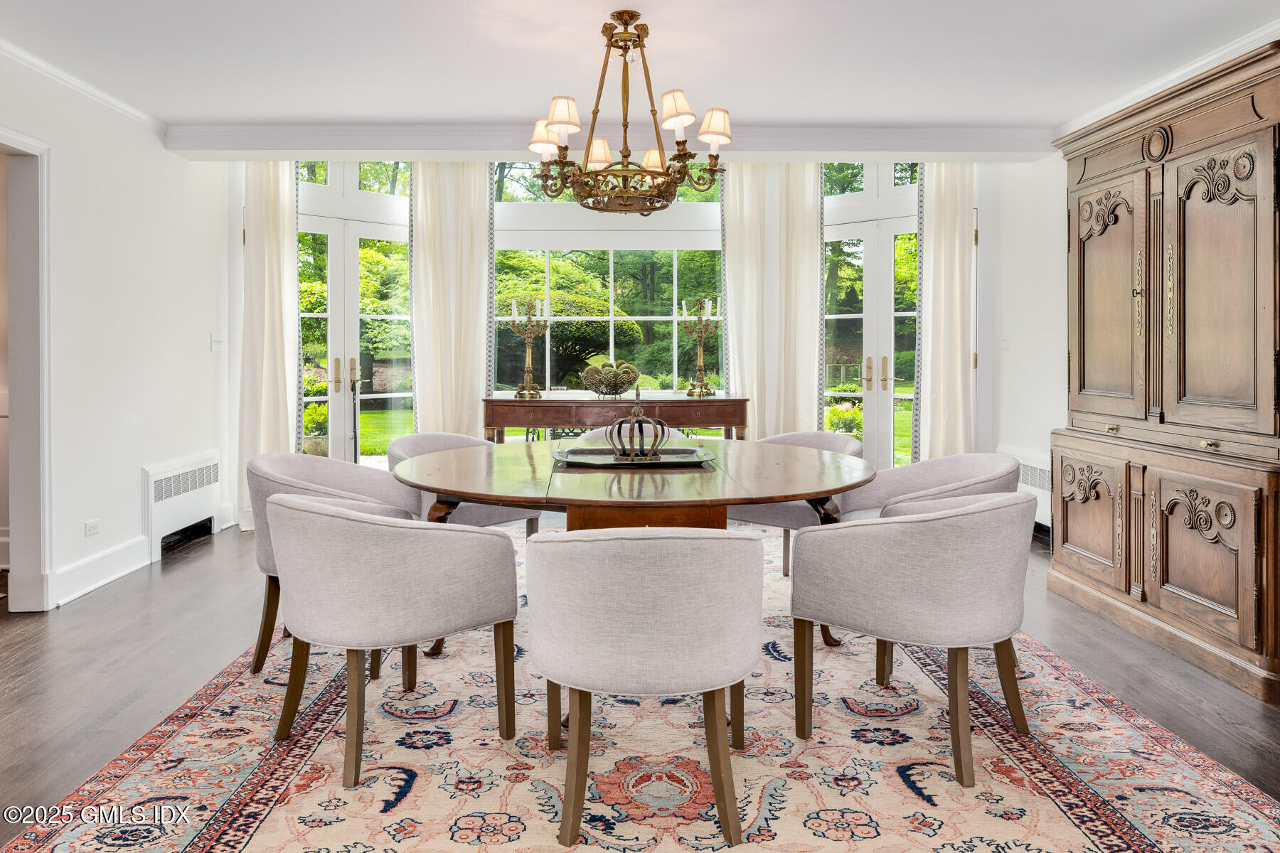 78 Khakum Wood Road Greenwich, CT 06831 - Photo 6 of 27 a dining room with furniture a chandelier and wooden floor