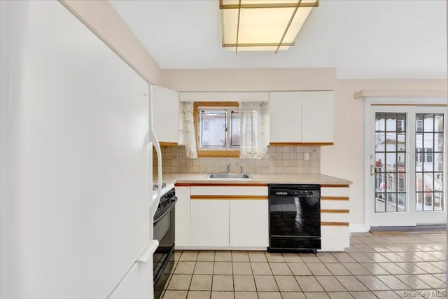 a kitchen with a sink cabinets and window
