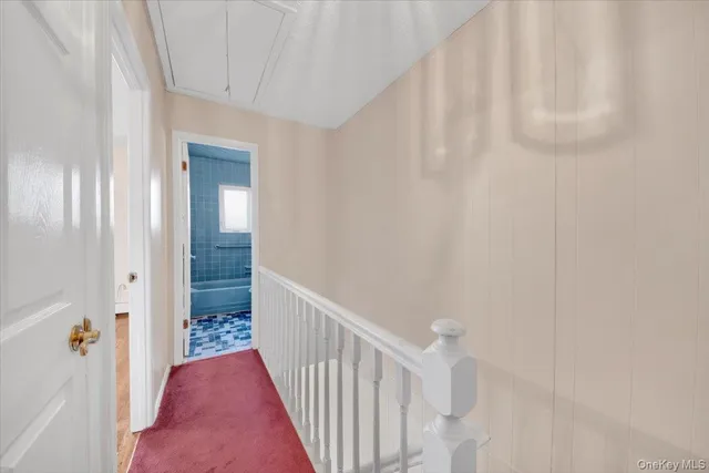 a view of a hallway with wooden floor and entryway