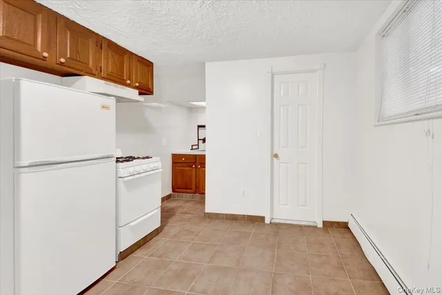 a view of a kitchen with a refrigerator
