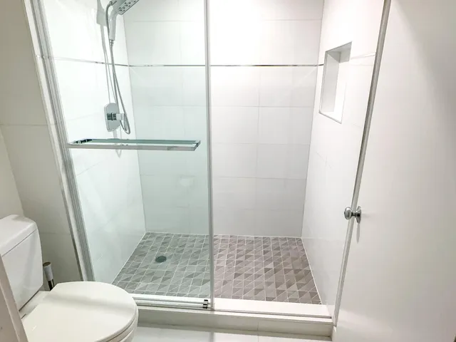 a large white kitchen with a large sink