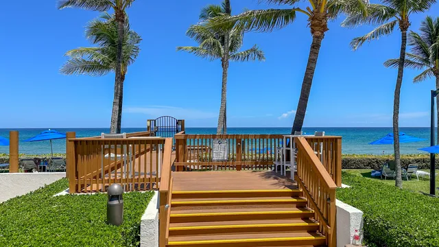 a living room with lots of furniture and view of kitchen