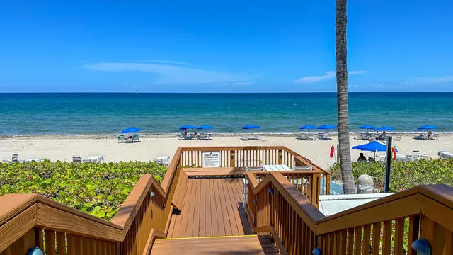 a living room with fireplace furniture and a large window