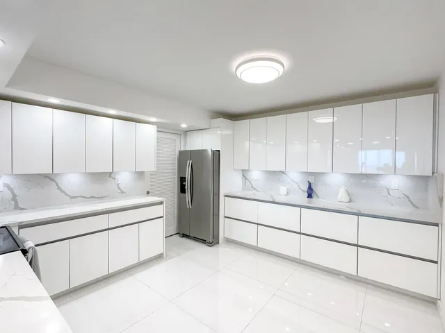 a kitchen with stainless steel appliances granite countertop a sink and a refrigerator
