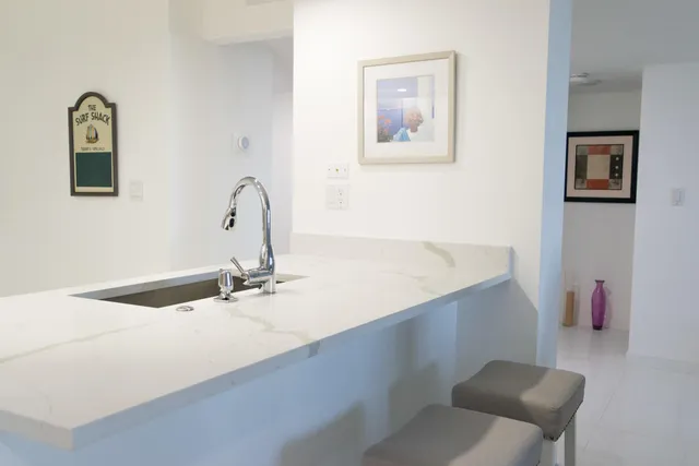 a large white bed in a white room