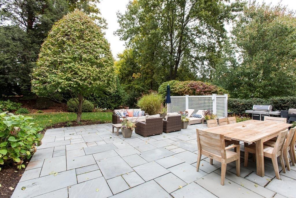 71 Hundreds Road Wellesley, MA 02481 - Photo 28 of 31 a view of a patio with table and chairs potted plants with wooden fence