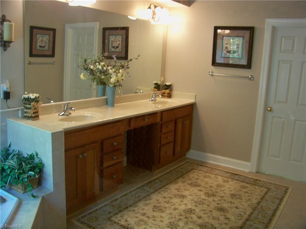5805 Autumn Gate Drive Oak Ridge, NC 27310 - Photo 19 of 30 Cherry cabinets and double bowl vanities...