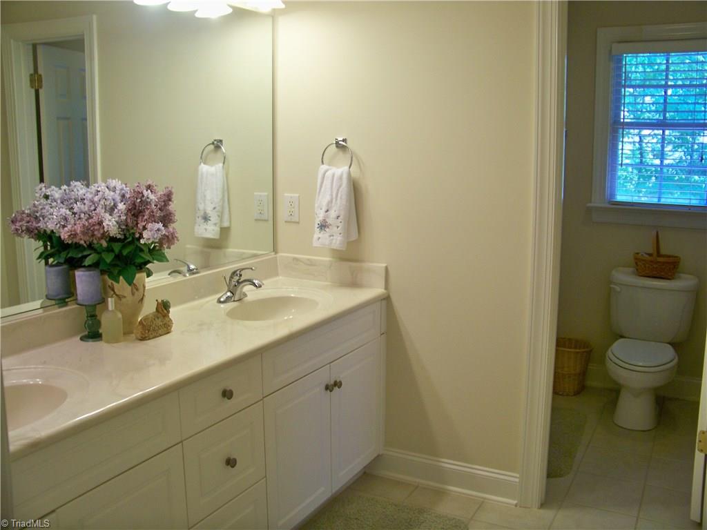 5805 Autumn Gate Drive Oak Ridge, NC 27310 - Photo 24 of 30 Extra large guest bath features double bowl vanities and a separate tub and commode area.