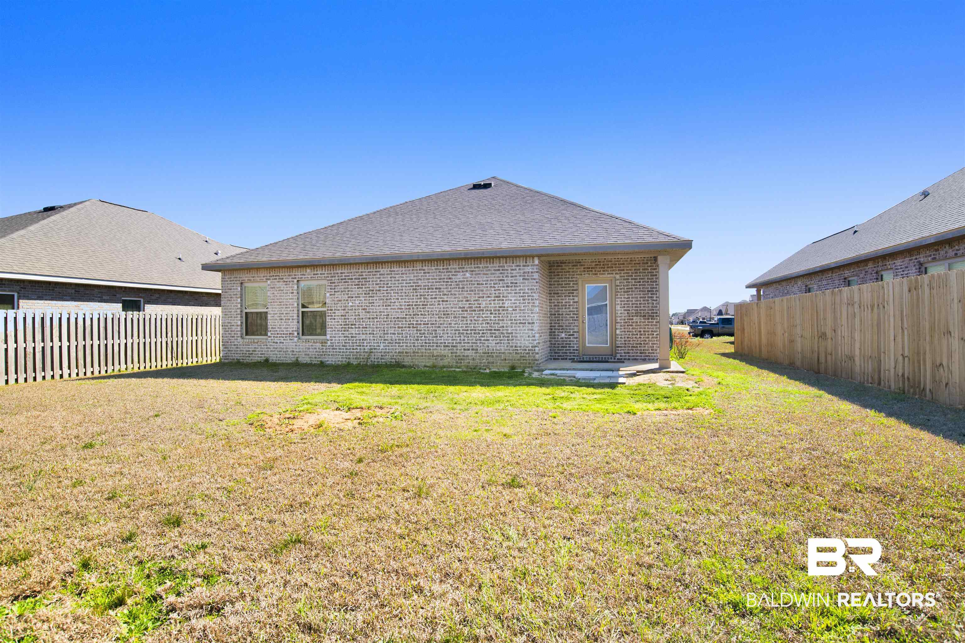 1174 Pheasant Circle Foley, AL 36535 - Photo 26 of 29 Rear view of property featuring a fenced backyard, brick siding, a patio area, and roof with shingles