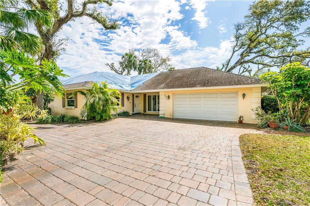 Undisclosed Address Vero Beach, FL 32963 - Photo 1 of 1 a front view of a house with a yard and a garage