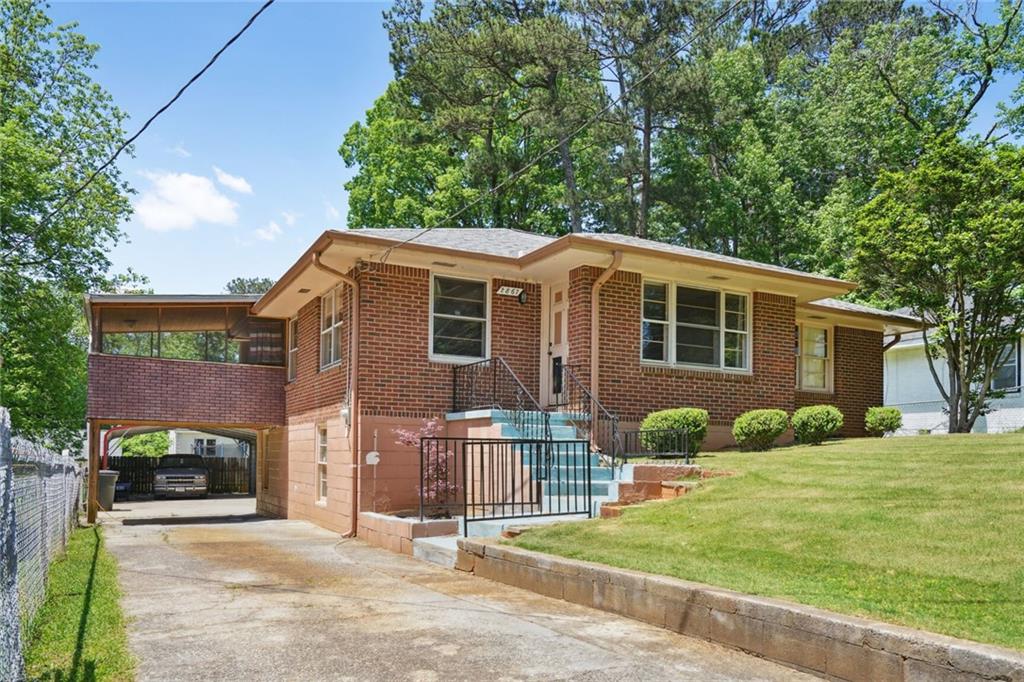 2867 Sylvan Road East Point, GA 30344 - Photo 1 of 1 a front view of a house with a yard