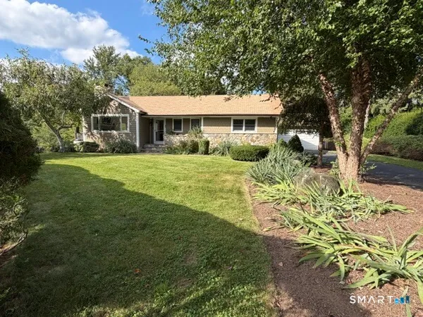 a front view of a house with a garden