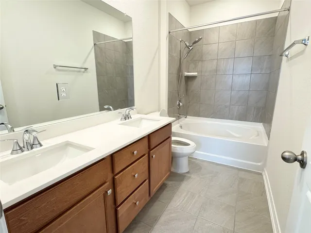 a bathroom with a double vanity sink toilet tub and shower