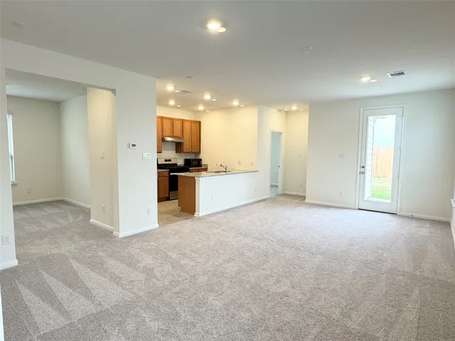 a view of a kitchen with a sink and a refrigerator
