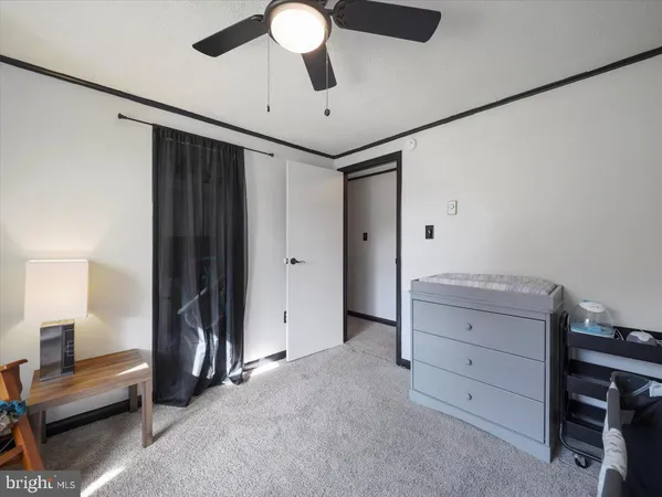 a room with furniture and a ceiling fan