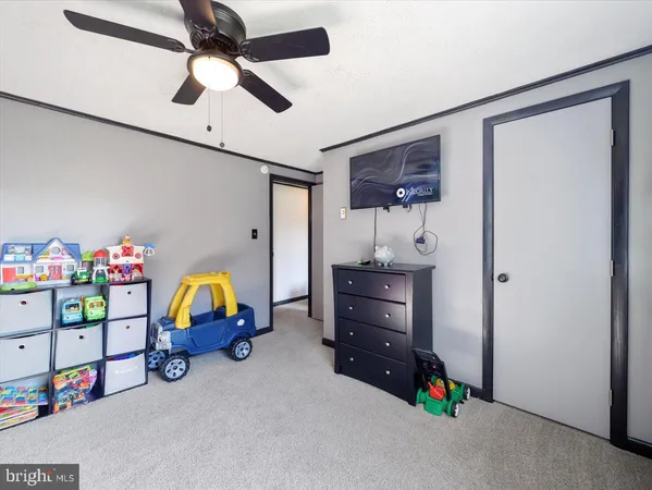 a bedroom with bed and a chandelier