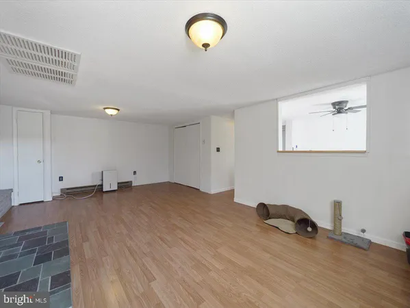 a view of a room with wooden floor and window