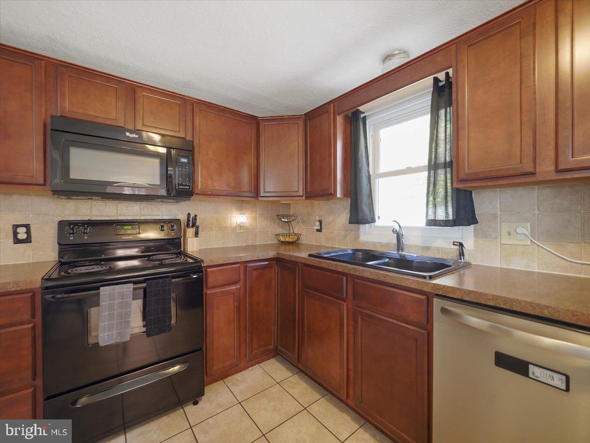 2731 Jack Road Chambersburg, PA 17202 - Photo 7 of 29 a kitchen with a sink stove and microwave