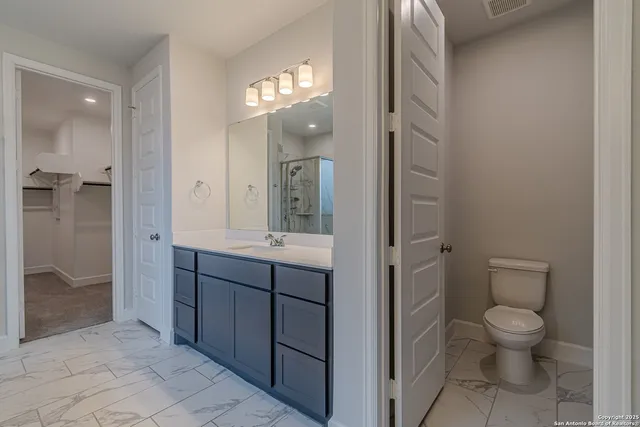 a spacious bathroom with a toilet sink and shower