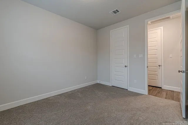 an empty room with closet area