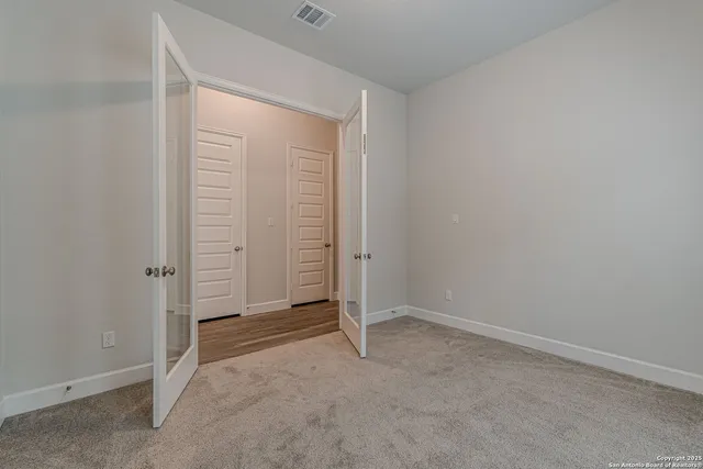 a view of backyard with large windows